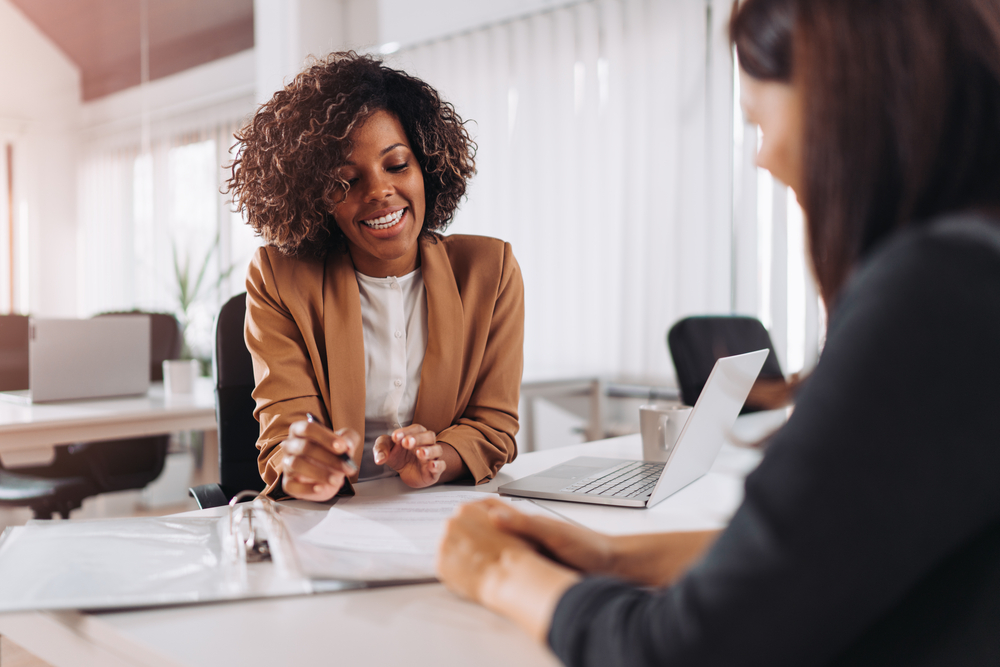 A new employee discusses small business health insurance benefits with her employer.