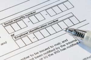 A woman completes an I-9 Employment Eligibility Verification form.