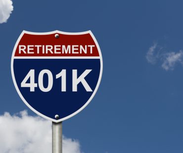 A U.S. interstate sign says “retirement” and “401k.”