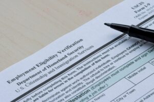 A woman fills out an I-9 Employment Eligibility Verification form.