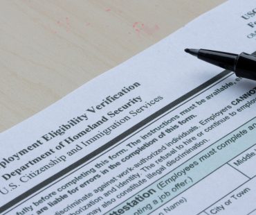 A woman fills out an I-9 Employment Eligibility Verification form.