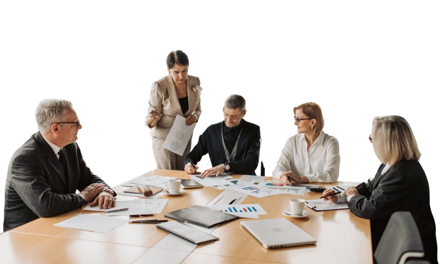 team sitting at a table going over charts and figures